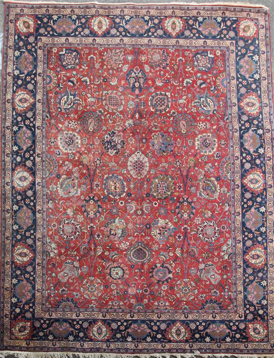 A Kirman red ground carpet, 14ft 1in by 10ft 10in.